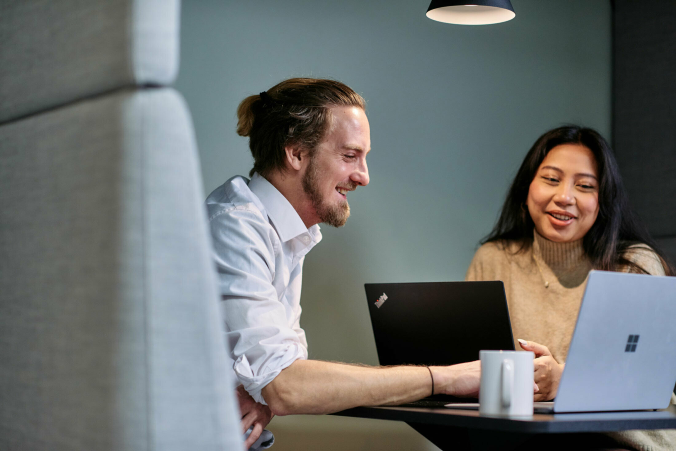 two people looking in laptop