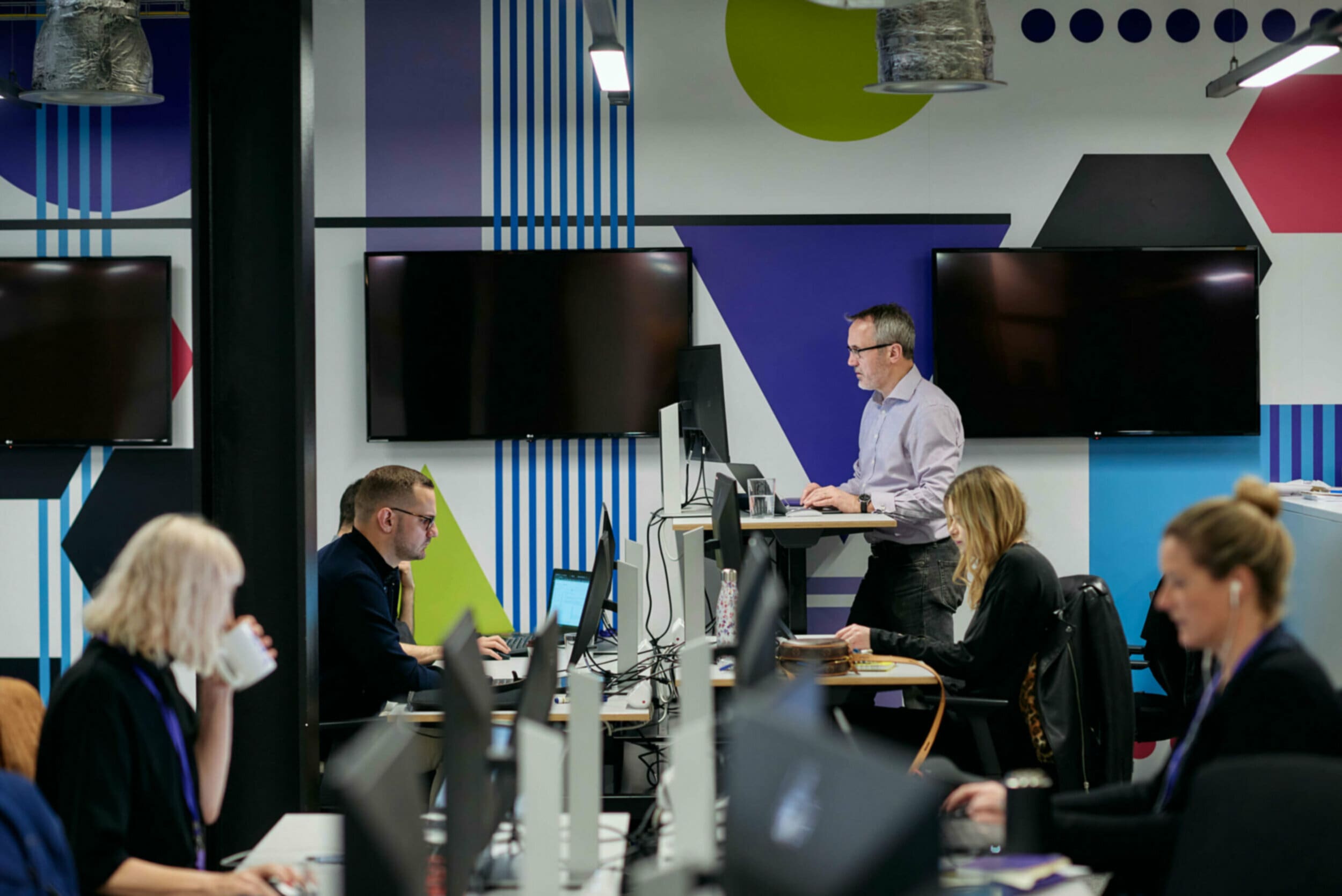 Multiple people working at desks in an office space