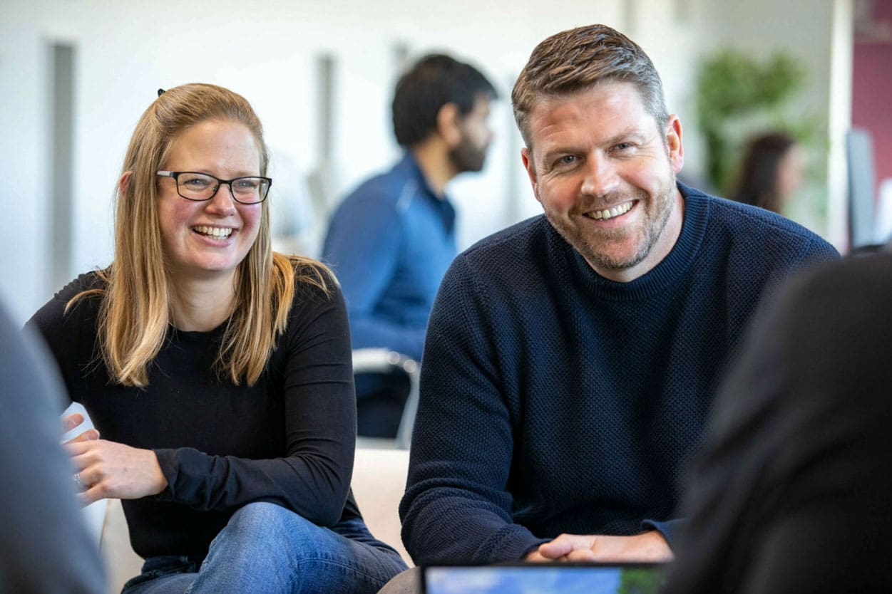 Man and woman smiling sitting together