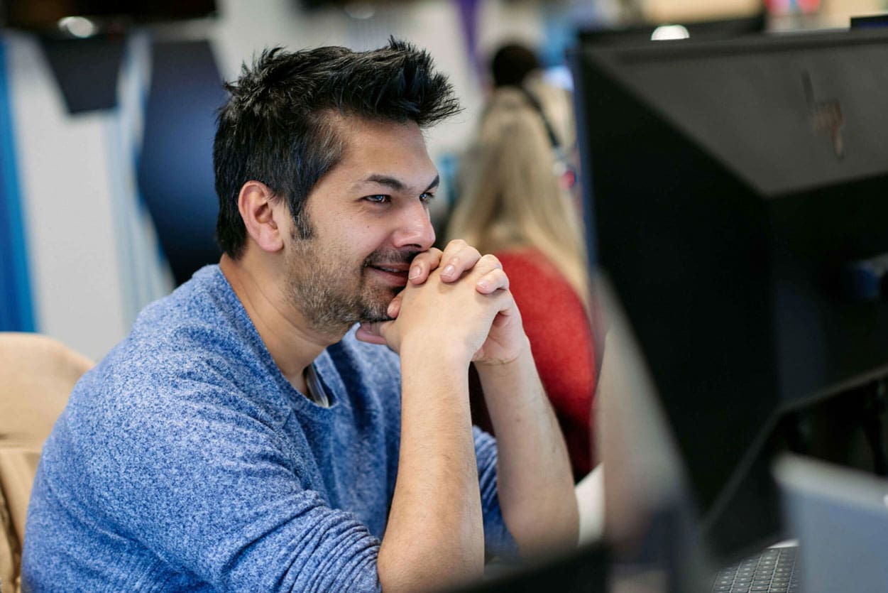 Man sitting at desk looking at computer