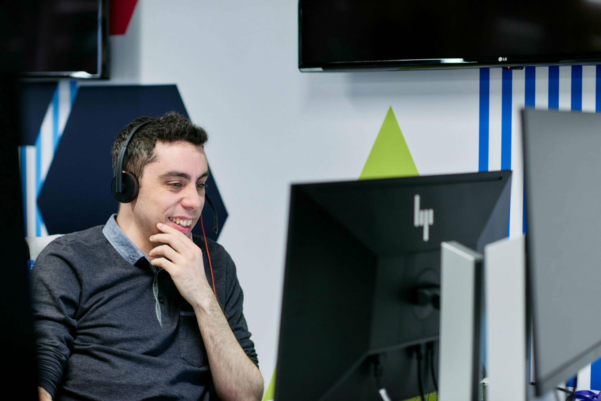 Man with headset working on a computer in the laptop