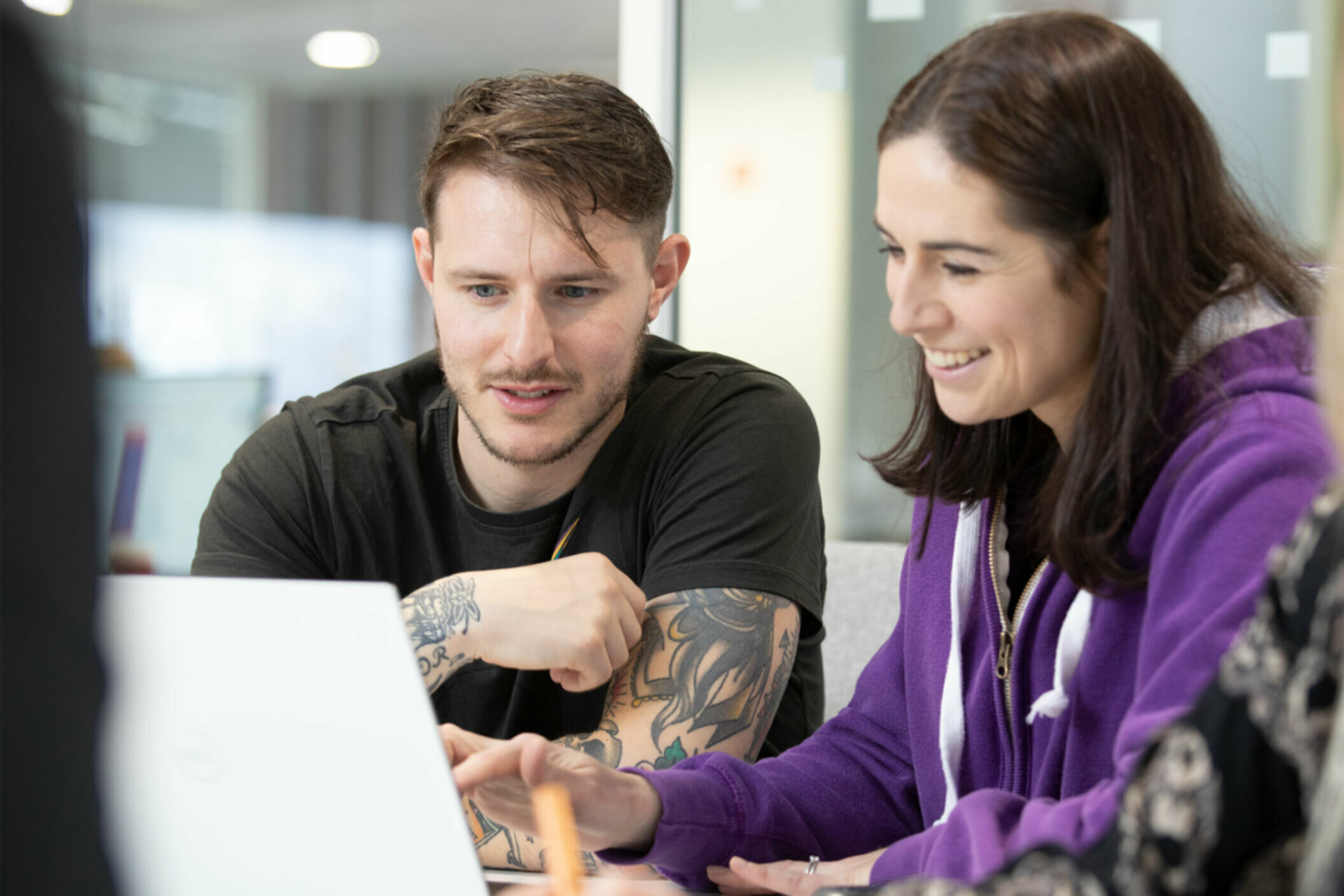 Man and lady looking at a laptop