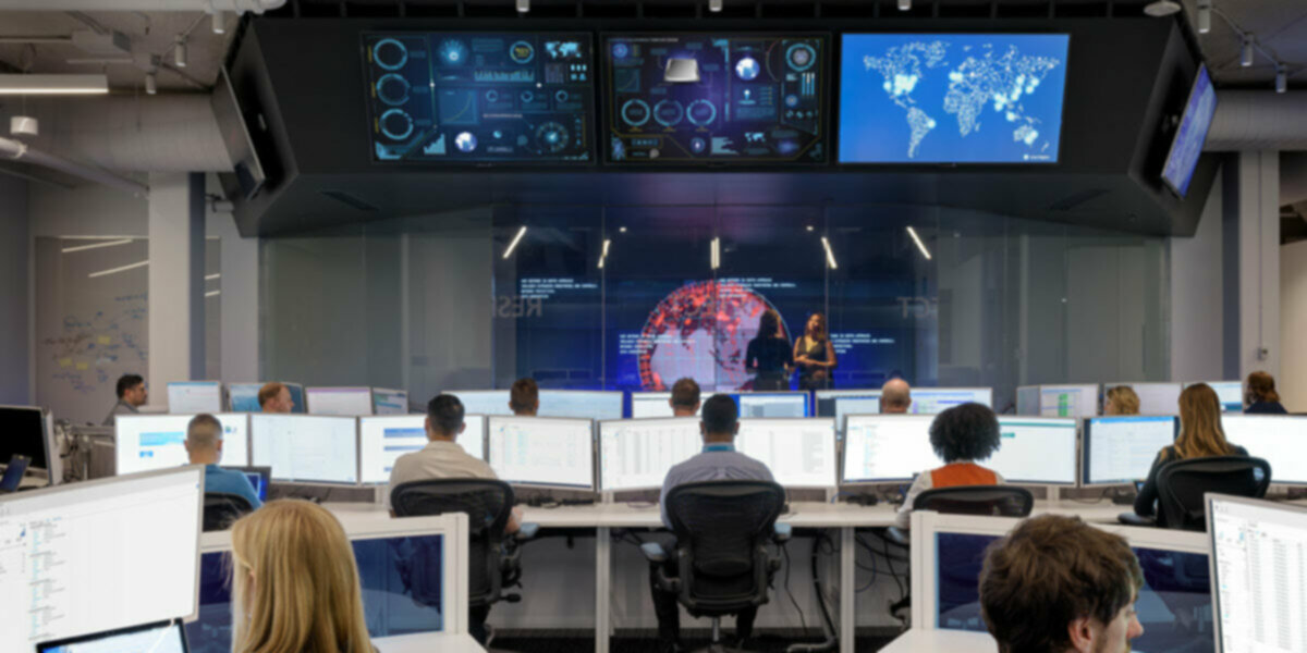Stock photo of office full of people sitting at computer desks