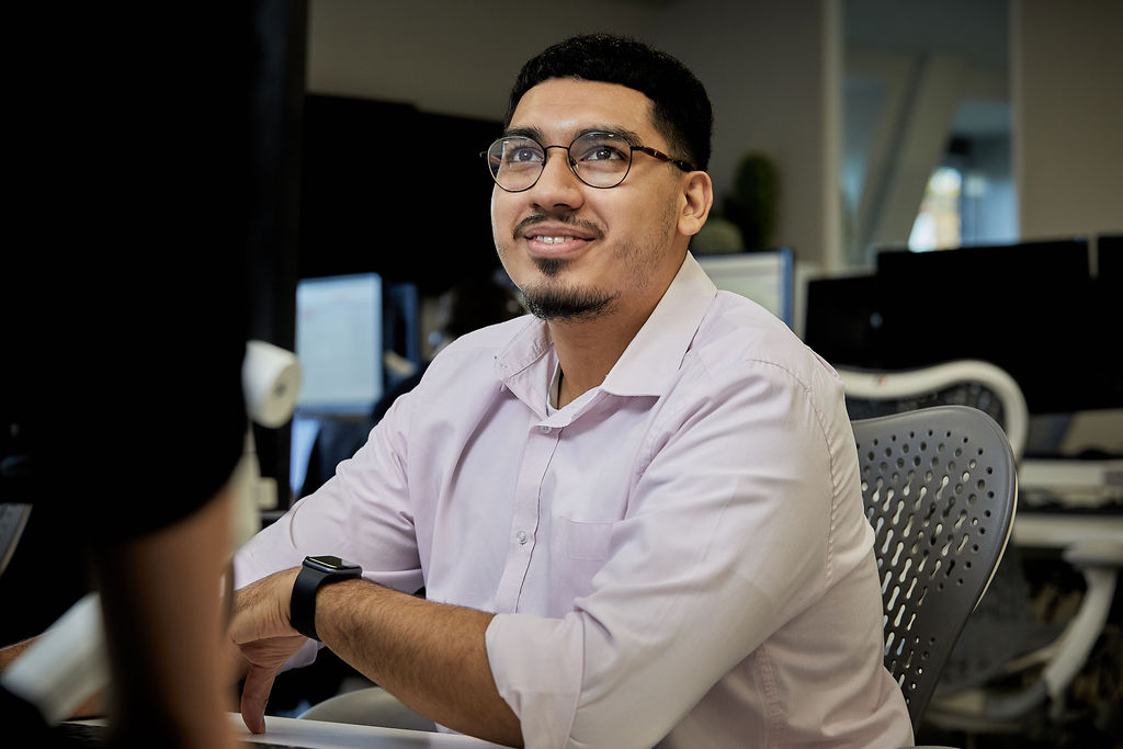 Man sitting at office desk smiling