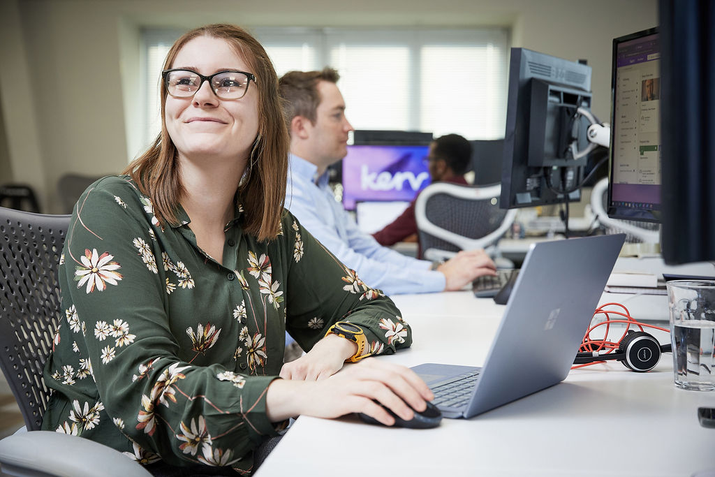 Woman sitting at office desk smiling