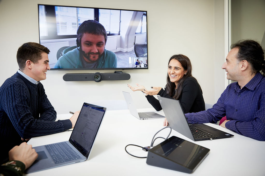 People having video call around a table
