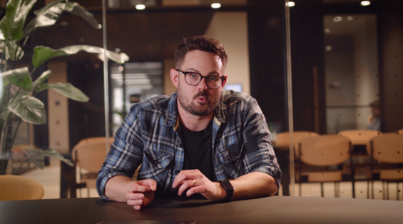 Man talking to camera in office setting