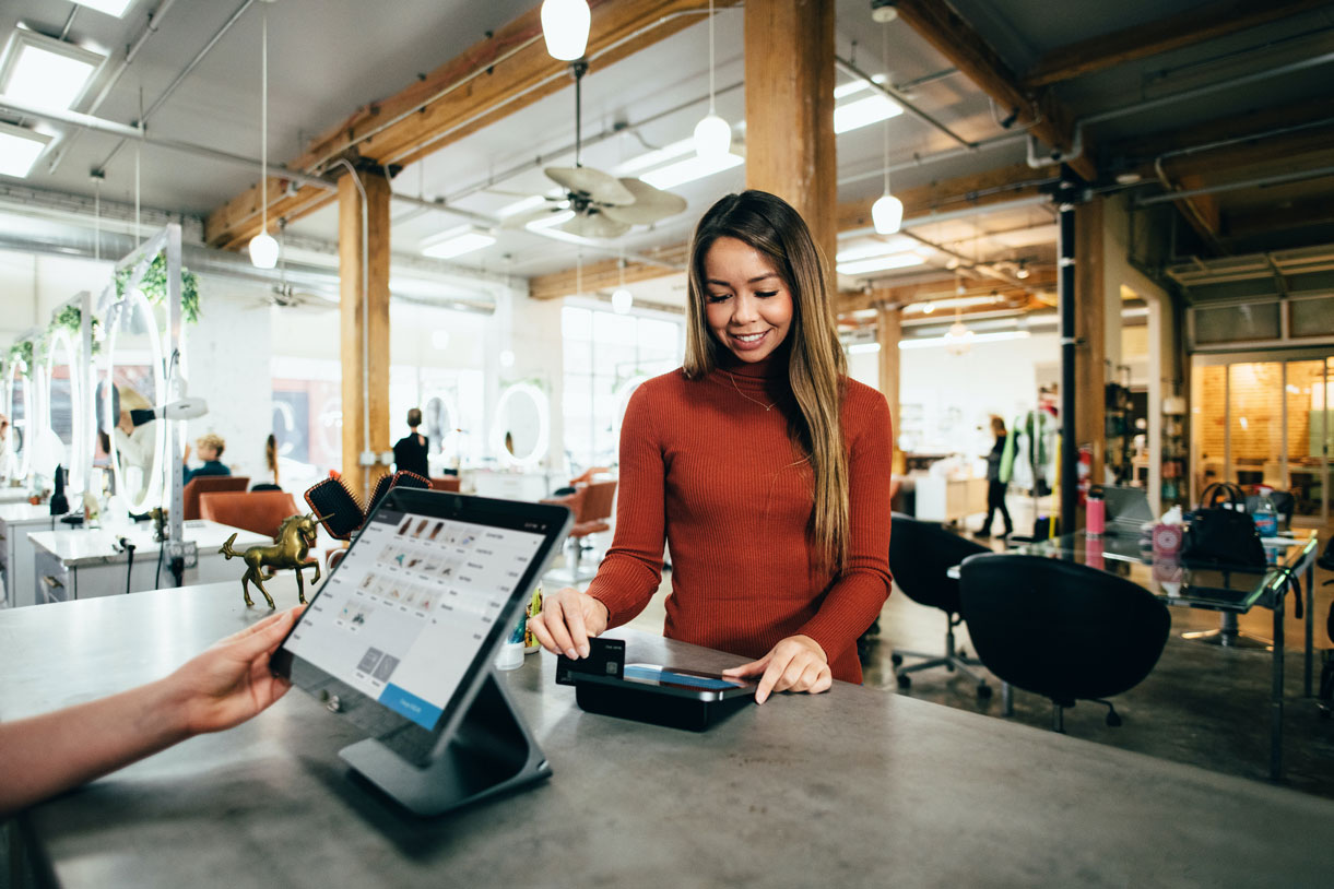 stock photo of woman paying with credit card at retail shop