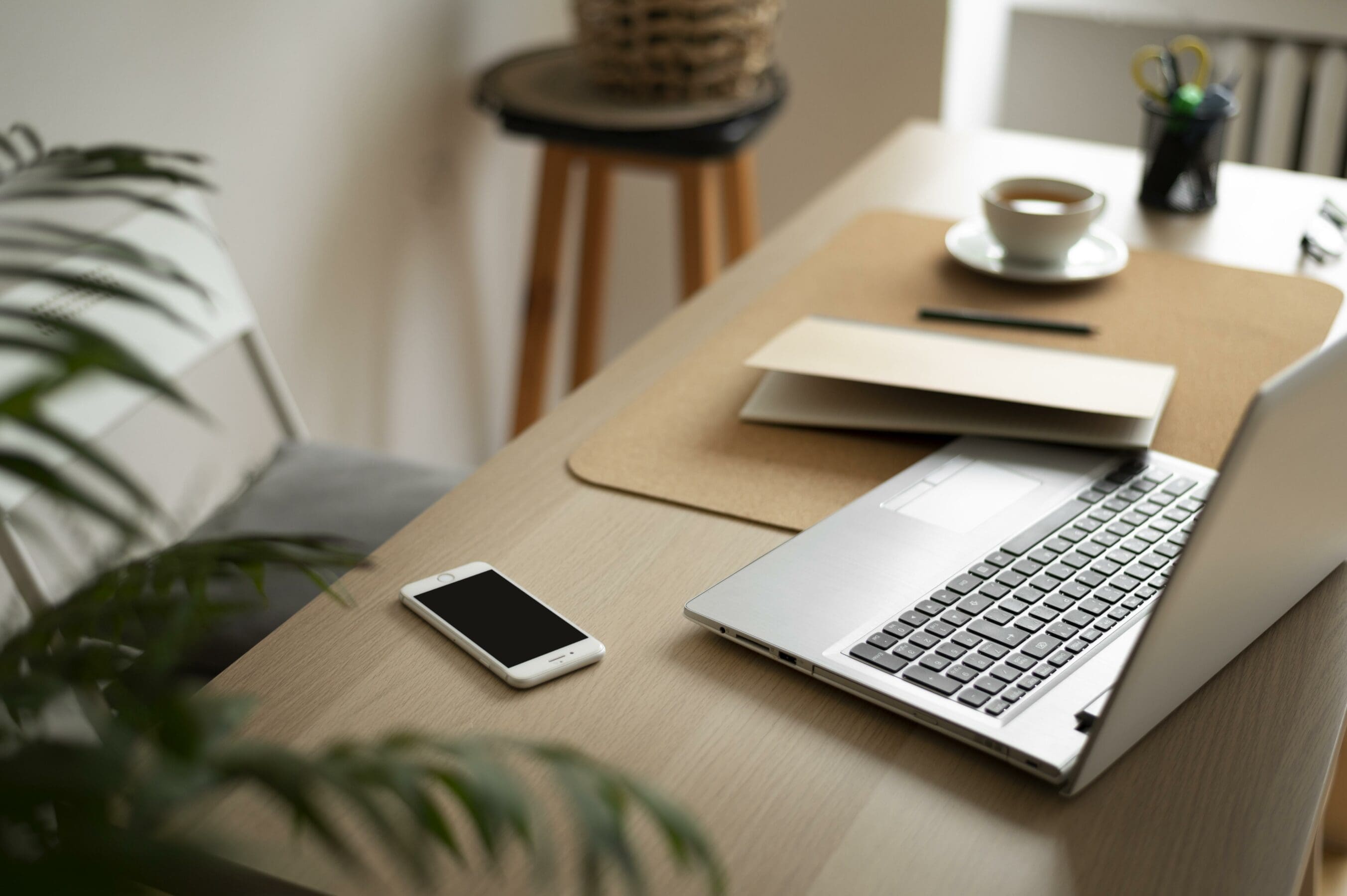 Stock photo of a desk with a laptop and phone