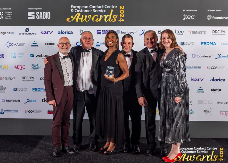 group of people smiling and receiving an award