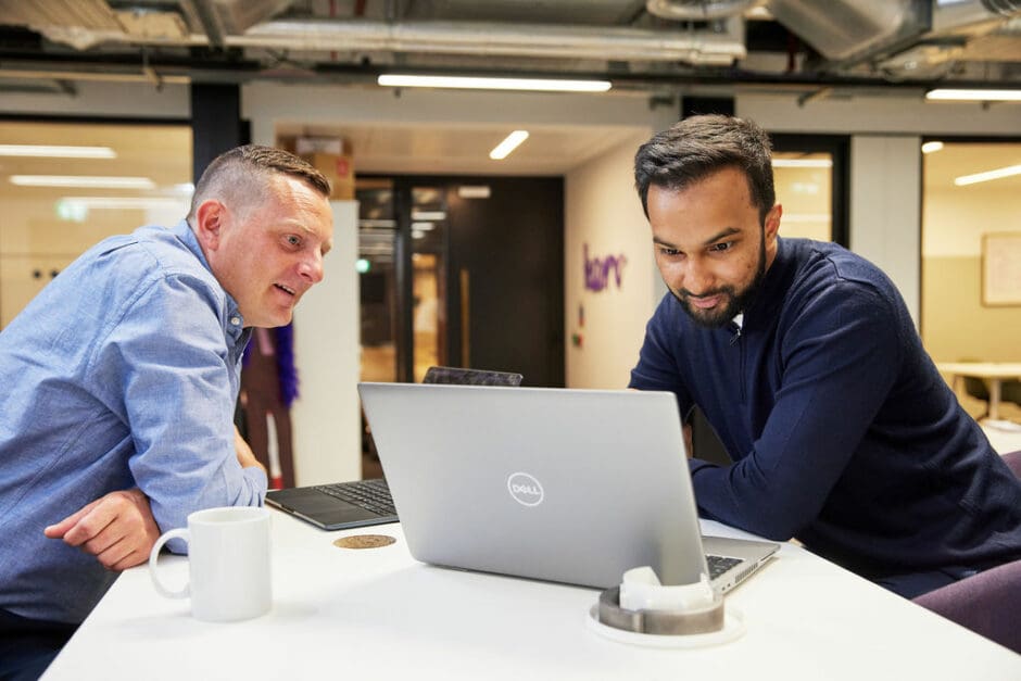 Two people working on laptop