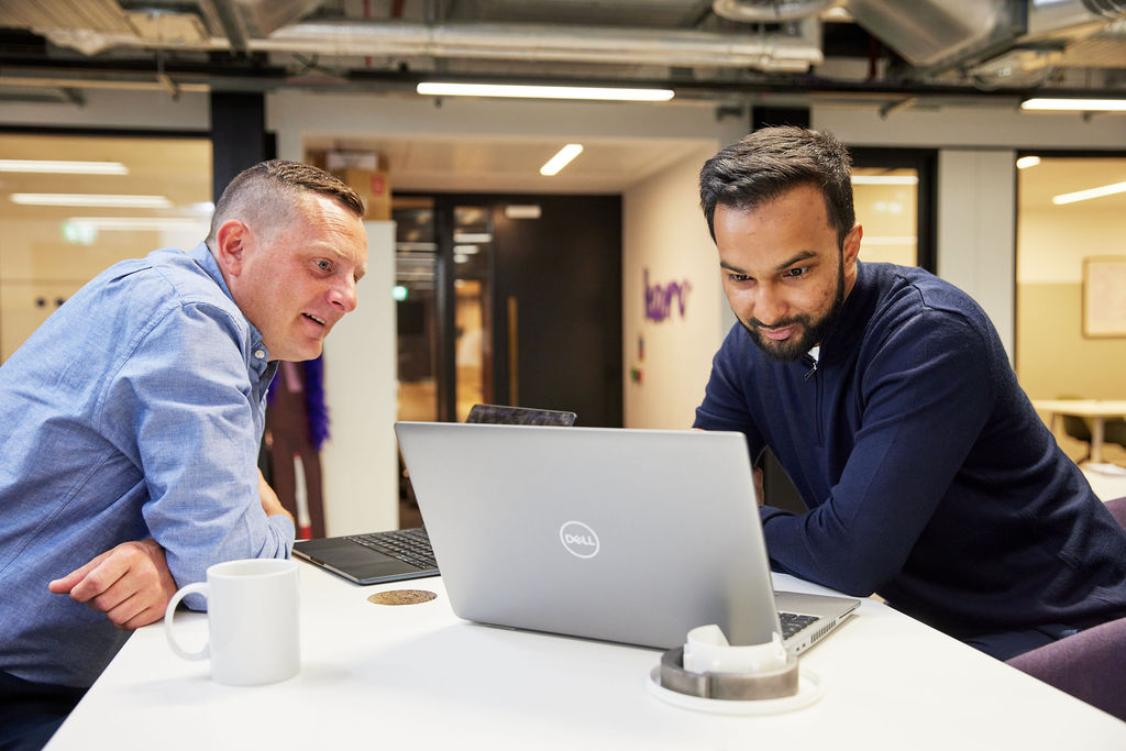 Two people working on laptop